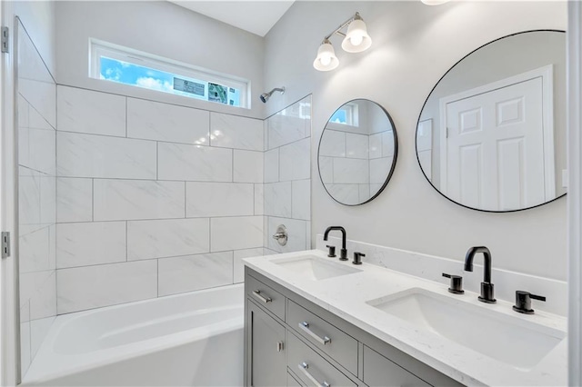 bathroom with vanity and tiled shower / bath combo