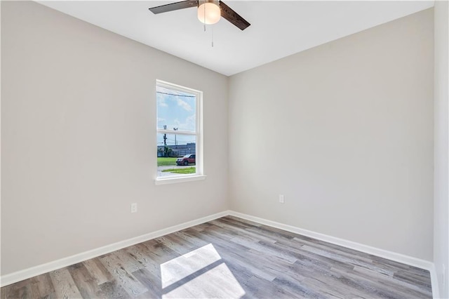 empty room with ceiling fan and light hardwood / wood-style flooring