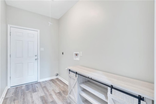 laundry area with electric dryer hookup, hookup for a washing machine, and light hardwood / wood-style flooring