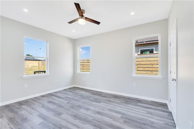 empty room with ceiling fan and hardwood / wood-style flooring