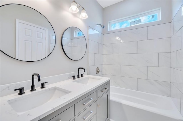 bathroom featuring vanity and tiled shower / bath