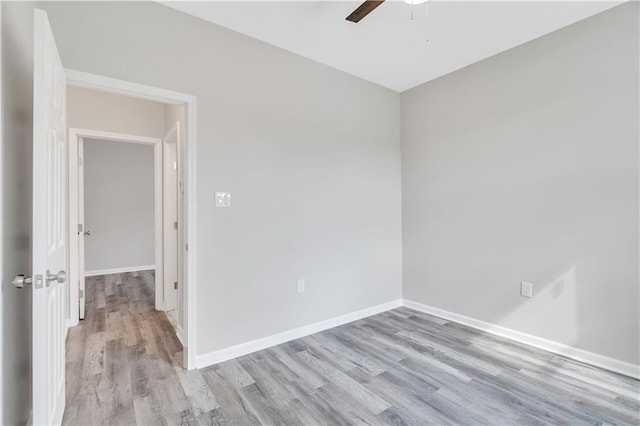 empty room with ceiling fan and light hardwood / wood-style floors