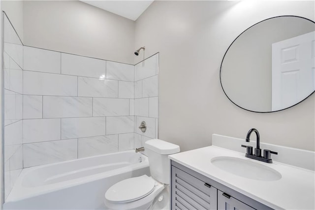 full bathroom featuring vanity, tiled shower / bath combo, and toilet