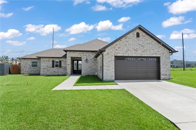 view of front facade with french doors, a front lawn, and a garage