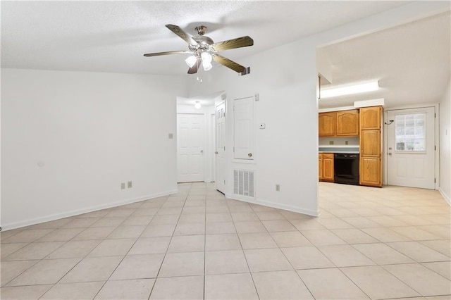 empty room featuring ceiling fan and light tile patterned floors