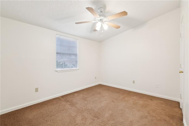 carpeted empty room featuring ceiling fan and a textured ceiling