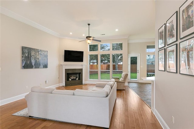 living room with ceiling fan, hardwood / wood-style floors, and ornamental molding