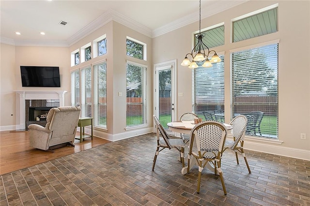 sunroom featuring a tile fireplace and a chandelier