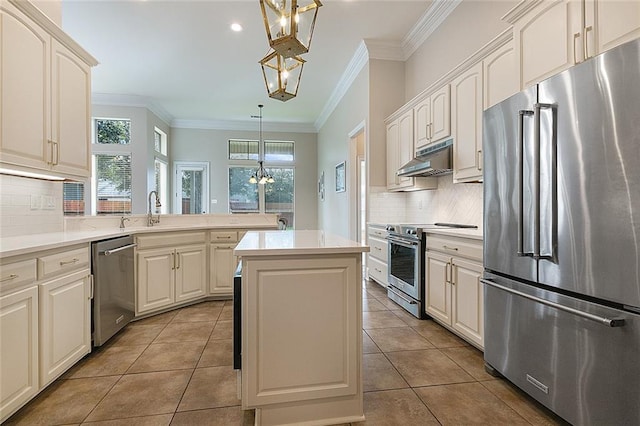 kitchen featuring backsplash, a chandelier, stainless steel appliances, and decorative light fixtures