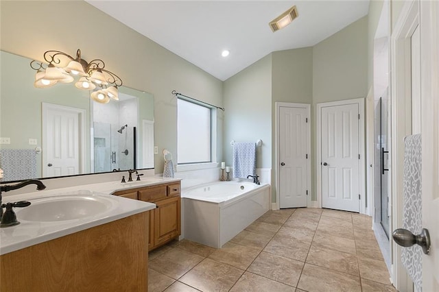 bathroom featuring tile patterned flooring, vanity, lofted ceiling, and plus walk in shower