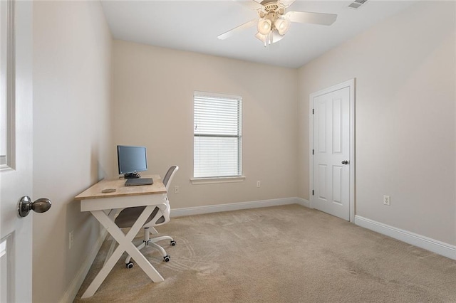 office space with ceiling fan and light carpet