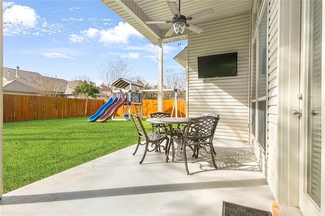 view of patio with a playground and ceiling fan