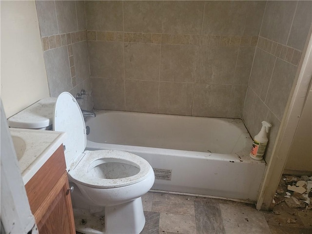 bathroom with a bathing tub, vanity, and toilet