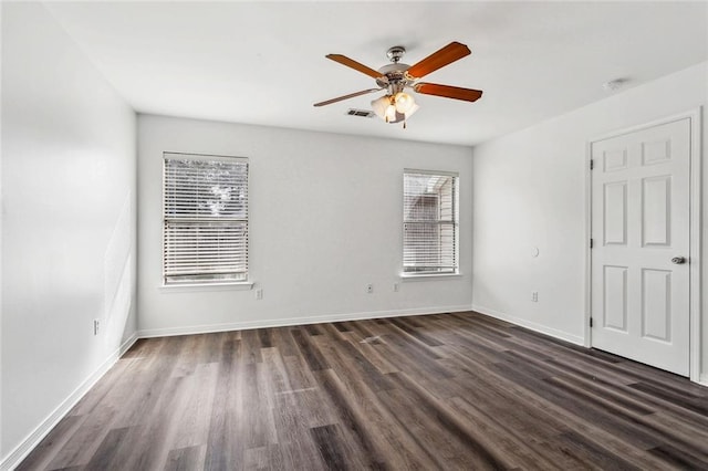 unfurnished room with ceiling fan and dark hardwood / wood-style flooring