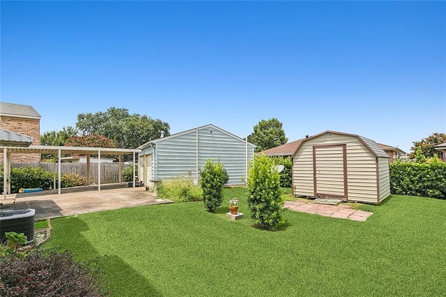 view of yard featuring a patio, central AC, and a storage unit