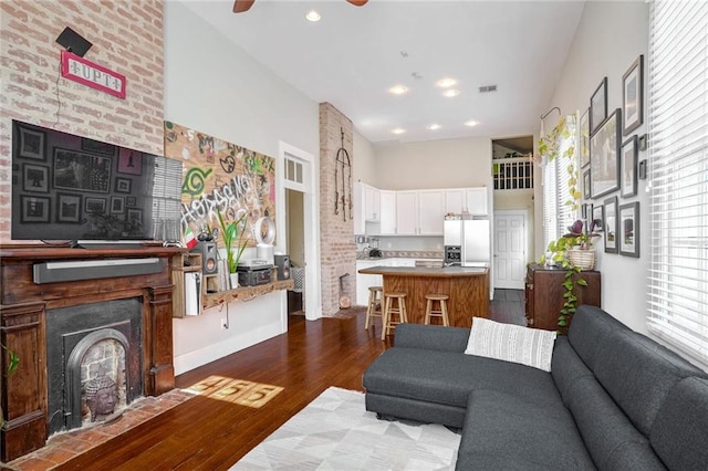 living room with wood-type flooring and ceiling fan