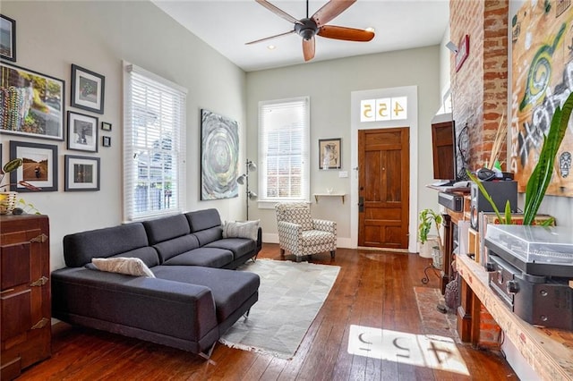 living room featuring dark hardwood / wood-style flooring and ceiling fan