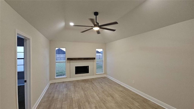 unfurnished living room featuring ceiling fan, lofted ceiling, and light hardwood / wood-style flooring