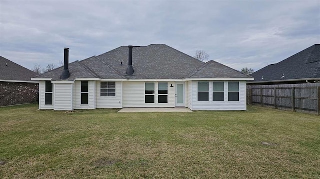 back of house featuring a patio area and a lawn