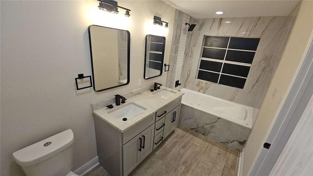 full bathroom with tiled shower / bath, vanity, and toilet