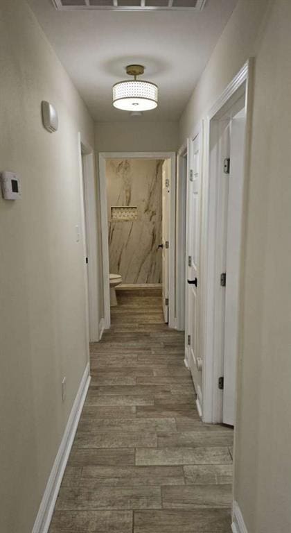 corridor featuring hardwood / wood-style floors