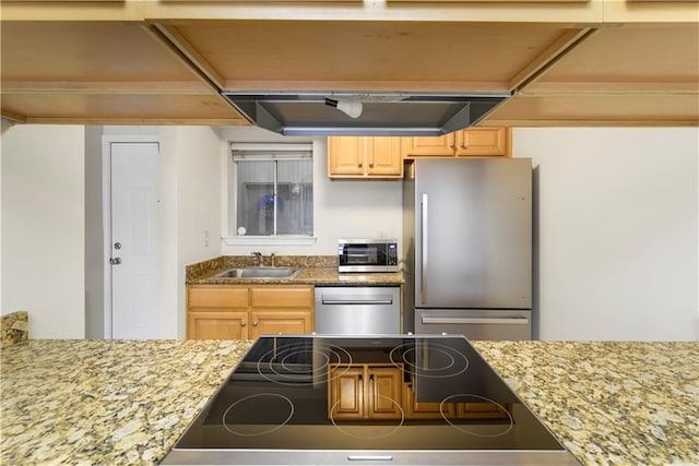 kitchen featuring light brown cabinetry, light stone counters, sink, and appliances with stainless steel finishes