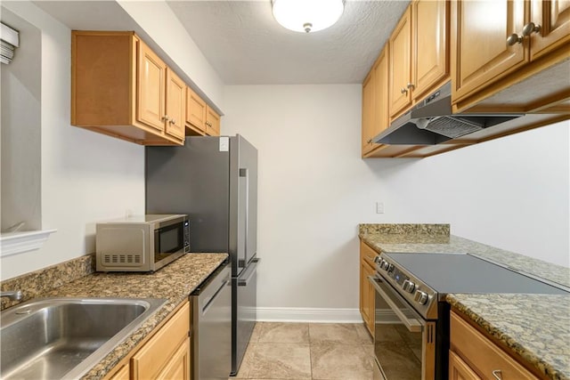 kitchen featuring stone counters, appliances with stainless steel finishes, light tile patterned floors, and sink