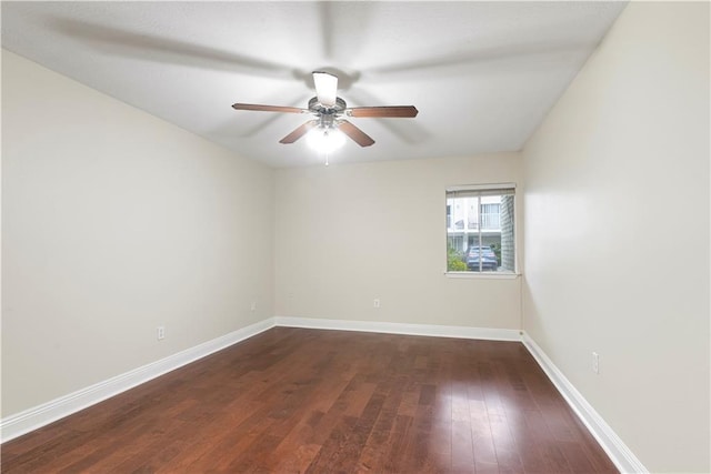 empty room with ceiling fan and dark wood-type flooring