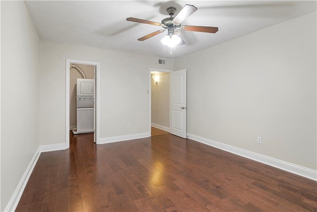 unfurnished bedroom with dark hardwood / wood-style flooring, a spacious closet, and ceiling fan