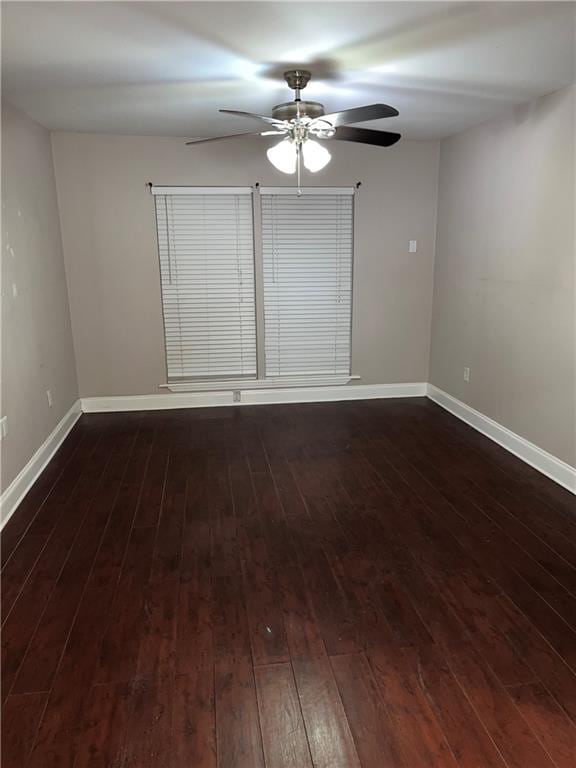 spare room featuring ceiling fan and dark hardwood / wood-style flooring