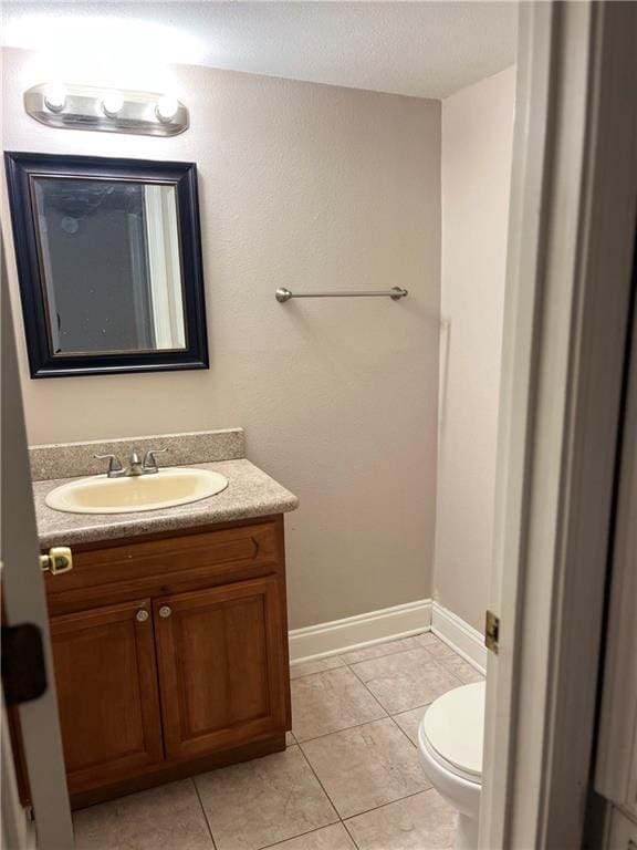 bathroom with tile patterned floors, vanity, and toilet