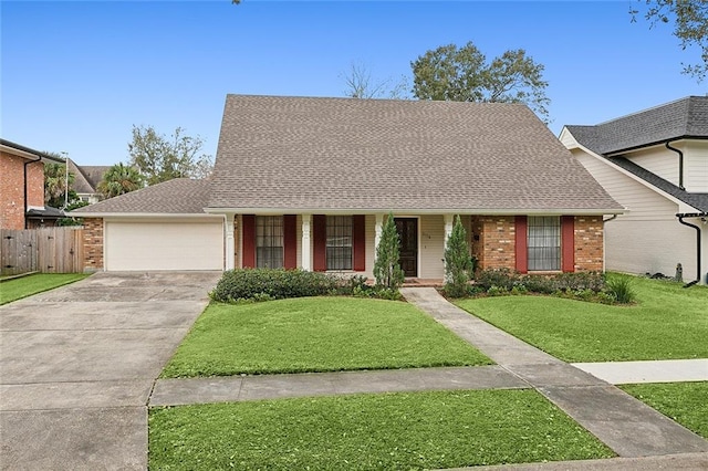 view of front of property with a front yard and a garage