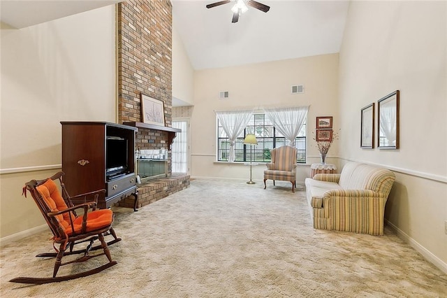 carpeted living room with a fireplace, high vaulted ceiling, and ceiling fan