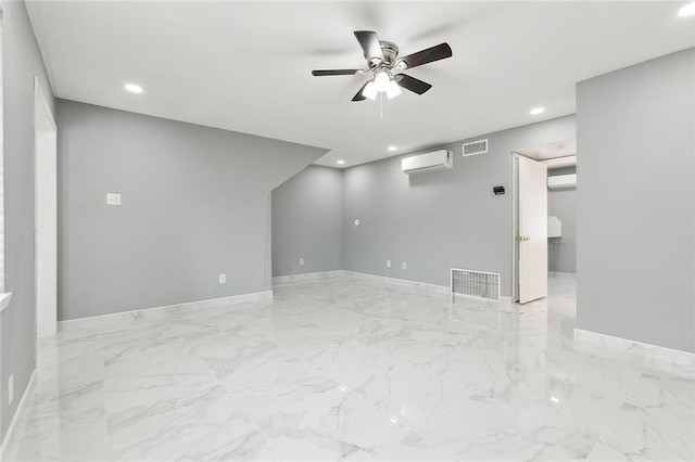 unfurnished room featuring a wall unit AC and ceiling fan