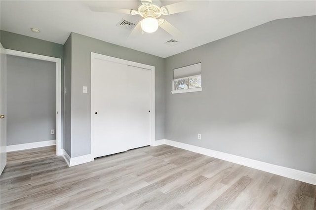 unfurnished bedroom featuring ceiling fan, a closet, and light hardwood / wood-style flooring