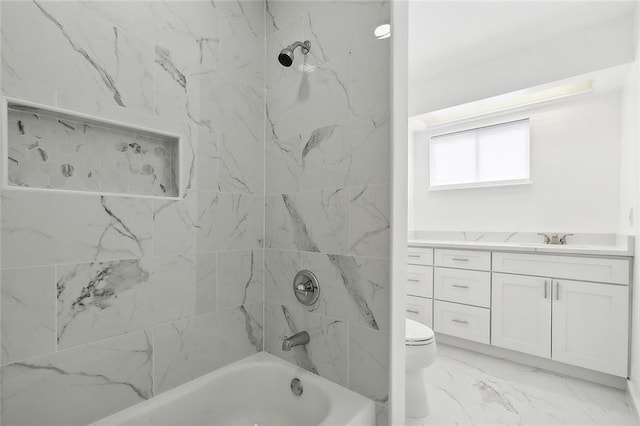 full bathroom with tiled shower / bath, vanity, and toilet