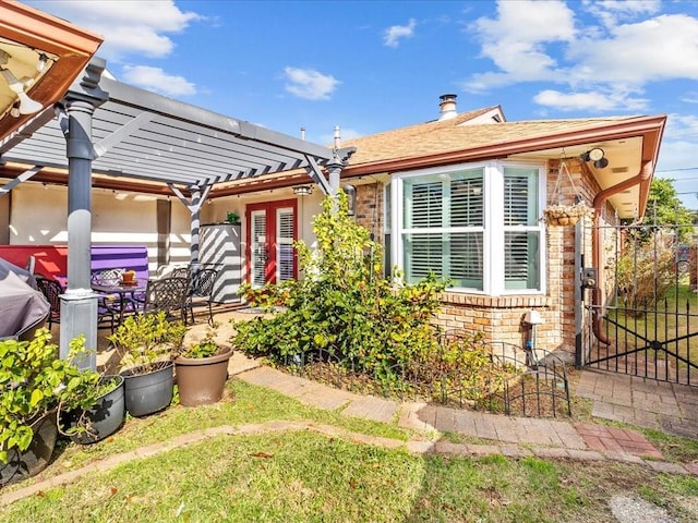 back of house with a pergola