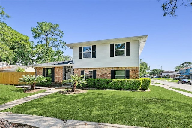 tri-level home with a front lawn