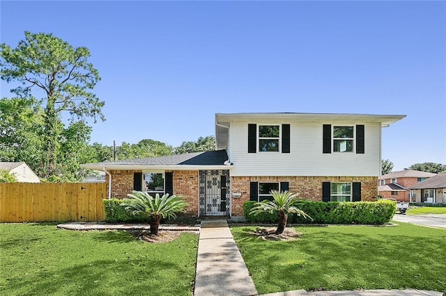 tri-level home featuring a front lawn