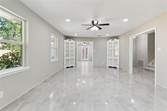 interior space with ceiling fan