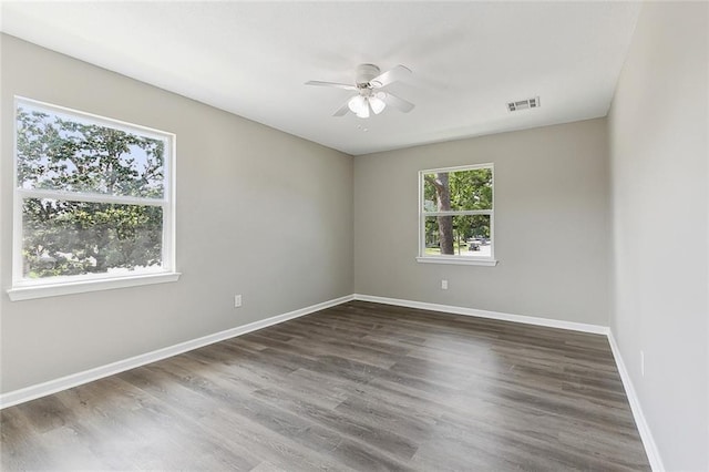 spare room with dark hardwood / wood-style floors and ceiling fan