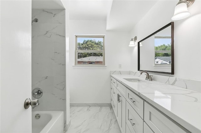 bathroom with tiled shower / bath and vanity