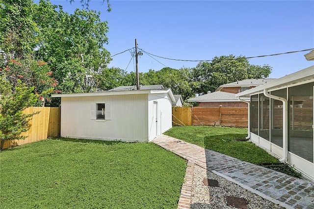 view of yard with an outdoor structure and a sunroom