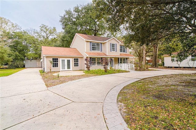 front of property featuring covered porch and an outbuilding