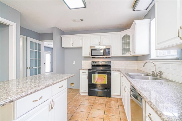 kitchen with stainless steel appliances, white cabinetry, a wealth of natural light, and sink