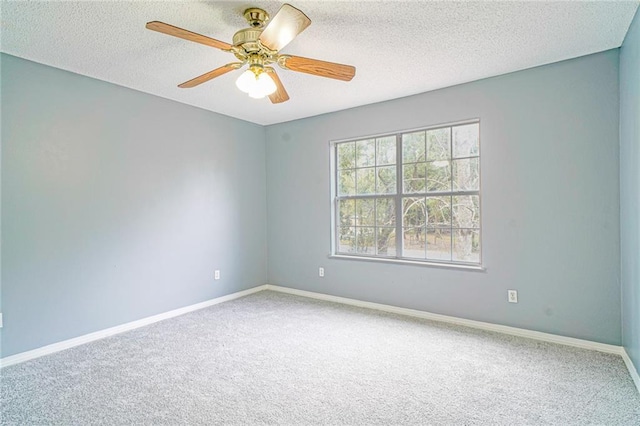 carpeted spare room with ceiling fan and a textured ceiling