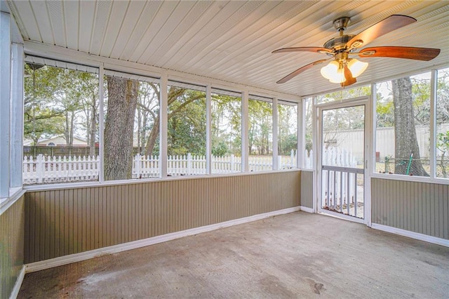 unfurnished sunroom with ceiling fan