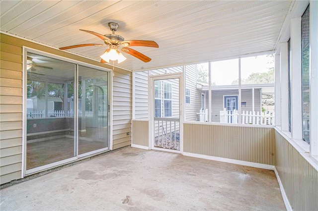 unfurnished sunroom with a wealth of natural light and ceiling fan