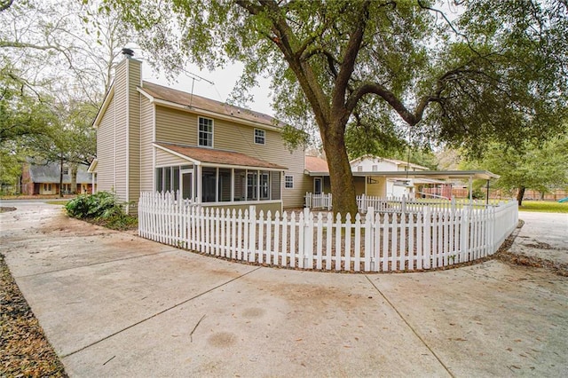 back of property featuring a sunroom