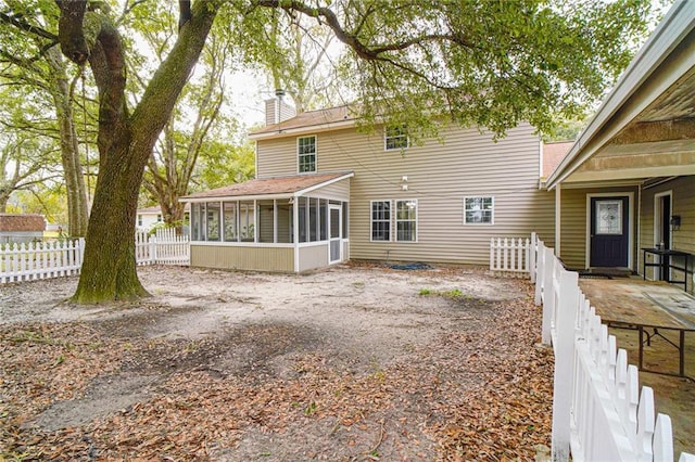 back of property featuring a sunroom